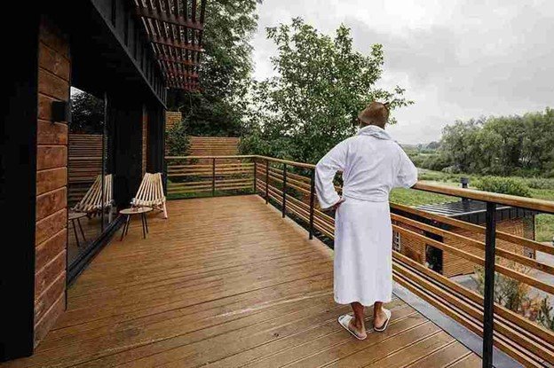 Newly built wood deck with railing overlooking a landscaped yard, showing professional deck construction and clean finishes.
