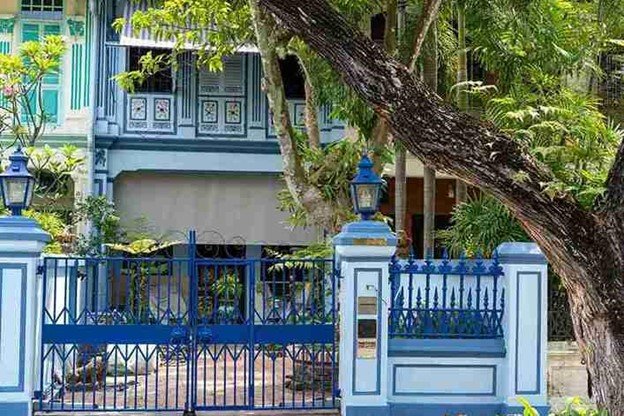 Decorative metal double gate installed at the front of a residential property with secure hinges and symmetrical alignment.