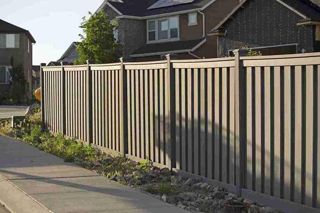 Long cedar privacy fence installed along a residential sidewalk, showing straight alignment and clean installation.